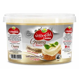 - Product: A tub of El Masreen Creamy Cheese with cheddar (full cream processed cheese spread) in a round plastic container with a transparent lid.
- Audience and styling: Appears targeted to general adult consumers (unisex) with a creamy cheeseblend look; label shows a spreadable cheese on a slice of bread, suggesting use as a spread or topping.
- Notable attributes: Creamy beige color of the cheese, cheddar flavor, 500 g tub, Arabic and English labeling, brand logo and image of a cheese dollop on bread, plastic container with white lid and gold-accent label band.