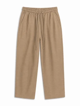 - What it is: A pair of wide-leg, relaxed-fit knit pants in a light brown/taupe color.
- Audience and styling cues: Designed for a unisex or casual wear vibe, with an elastic drawstring waistband and side pockets, suggesting comfortable loungewear or casual daytime styling.
- Materials and features: Visible soft knit fabric (likely cotton or cotton-blend), matte finish, solid neutral color, wide straight-leg silhouette, mid-length cropped to ankle.