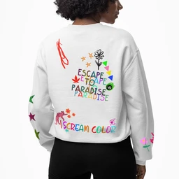 - A white oversized crewneck sweatshirt featuring colorful, playful graphic elements across the back and sleeves. 
- Appears designed for women or unisex styling, based on model fit and how it drapes. 
- Notable attributes: bright multicolor lettering (SCREAM COLORS) and scattered whimsical icons (flowers, stars, shapes), with loose, relaxed fit and standard crew neckline. Material suggests a soft fleece or cotton blend; overall vibe is bold, graphic, and casual.