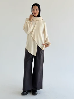 Product: Wide Leg Pants - Gray

- Audience: Unisex or women's, based on the model styling and fit.
- Visible attributes: The pants are wide-leg with a relaxed, loose silhouette and a dark gray color. The fabric appears to be a soft, possibly matte material. The pants are full-length, pairing with a layered cream top in the photo. No visible patterns or embellishments on the pants themselves.