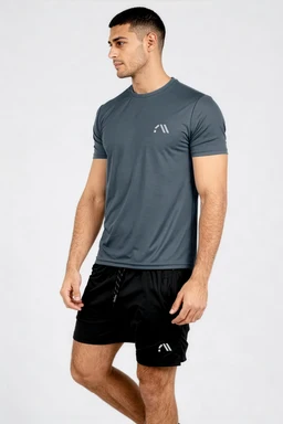 - What the product is: A men's athletic short-sleeve performance tee in teal/blue-gray, shown on a male model wearing black athletic shorts.
- Apparent audience and styling: Designed for men; slim, fitted cut with a crew neck, short sleeves, and a minimalist logo on the left chest. The model’s athletic build and pairing with black athletic shorts suggest a compression/activewear top for workouts.
- Notable attributes: Lightweight, moisture-wicking fabric with a smooth, matte finish. Teal/blue-gray colour, minimal white logo accent, clean crew neckline, and a streamlined, athletic fit.