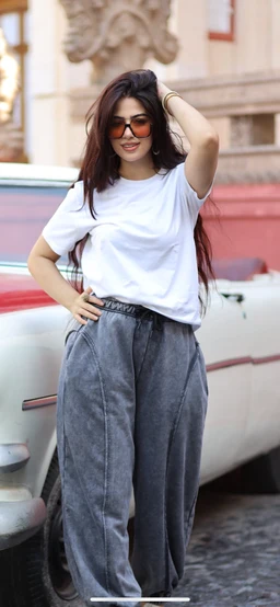 The product appears to be a casual women's pant. The model is wearing high-waisted, wide-leg, washed gray denim-style pants with a relaxed, loose silhouette and a front crease. Fabric looks like sturdy cotton/denim with a faded gray wash; styling is paired with a simple white T-shirt and sunglasses for a streetwear, everyday look.