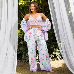 - It shows a three-piece kimono set designed for a relaxed, lounge or beachwear look. The model wears a lace bralette top with a matching light kimono robe and printed wide-leg pants, all in soft pastel tones.

- Target audience appears to be women, based on the model, cut, and styling. Visible materials and colors include a pale lavender tone with floral and tropical leaf prints; the fabrics look soft, lightweight, and flowy, with lace detailing on the bralette and delicate edging on the pants.
